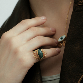 Gold-tone ring with dark green stone