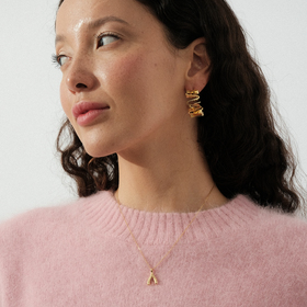 Golden semi-circular earrings in the form of a wave