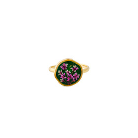 A small round golden green ring with white and pink flowers