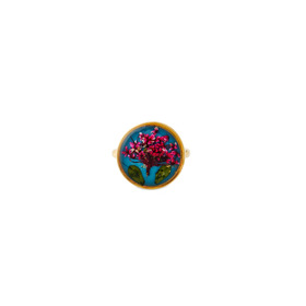 A large golden round blue ring with pink flowers