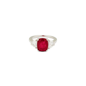 A silver ring with a large red crystal