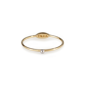 Thin yellow gold ring with a white ball