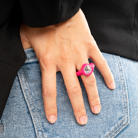 Bright pink polymer clay ring with a large transparent rhinestone