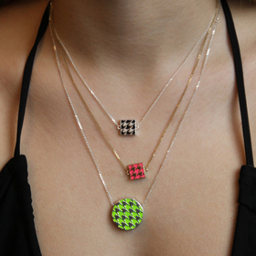 mini double-sided silver necklace with neon and black enamel houndstooth pattern