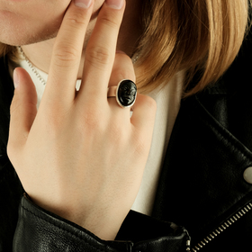 Small silver-plated ring with a face-shaped black porcelain cabochon