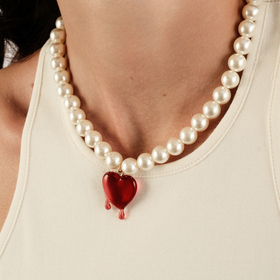 Necklace made of white beads with a heart pendant