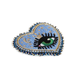 heart brooch with an eye on the starry sky background
