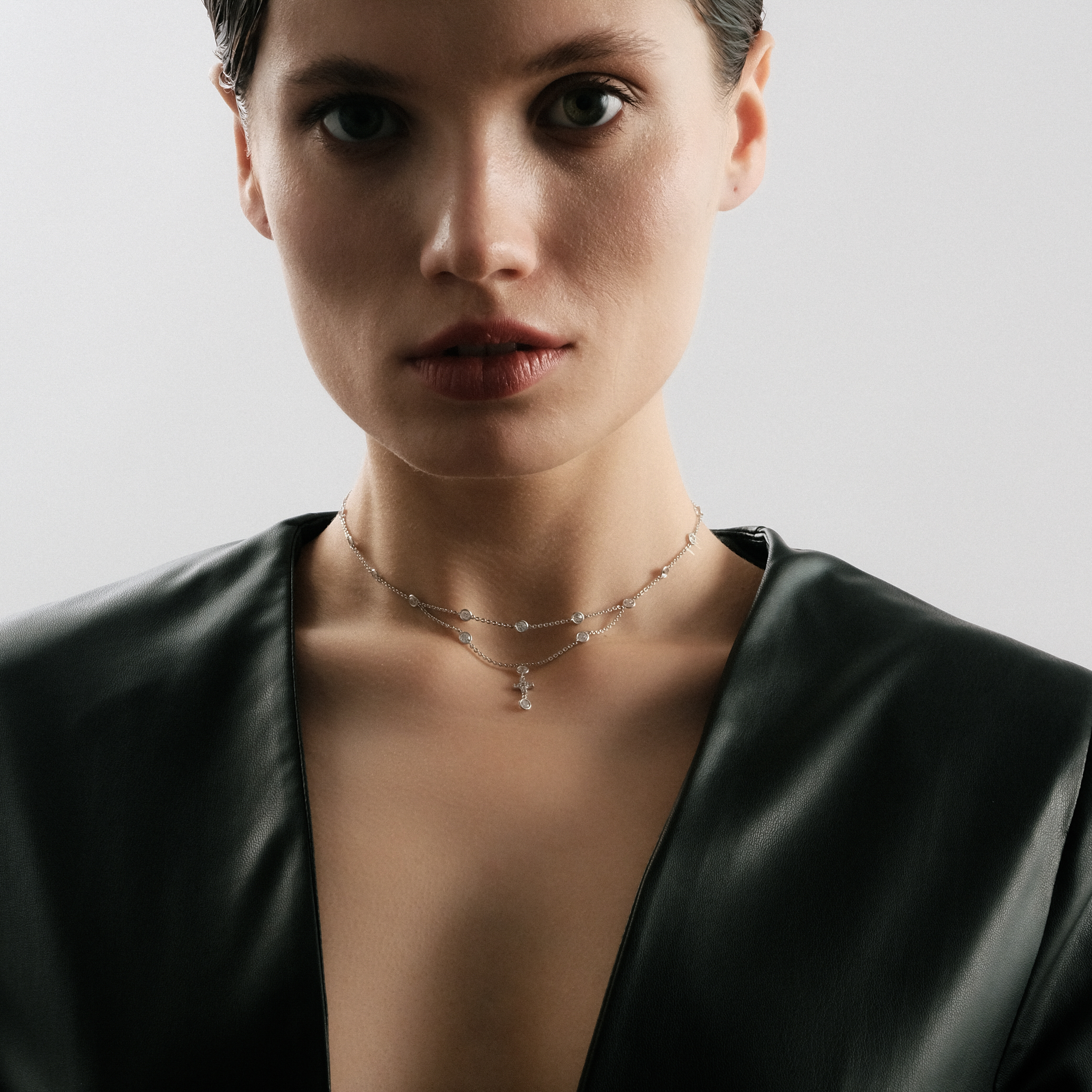 Silver choker necklace with a cross on a hanging chain buy at