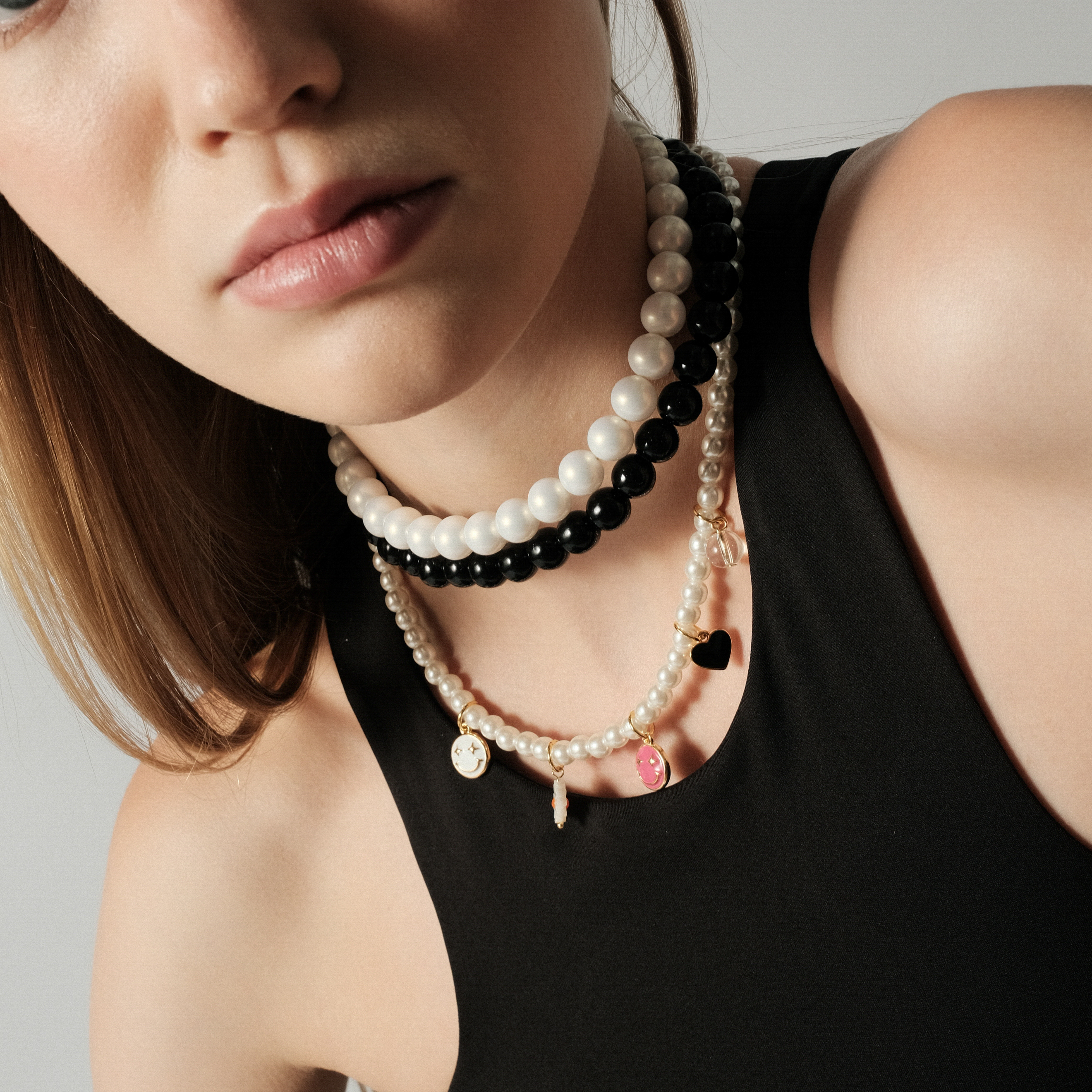 Necklace made of white beads with multicolored smile pendants